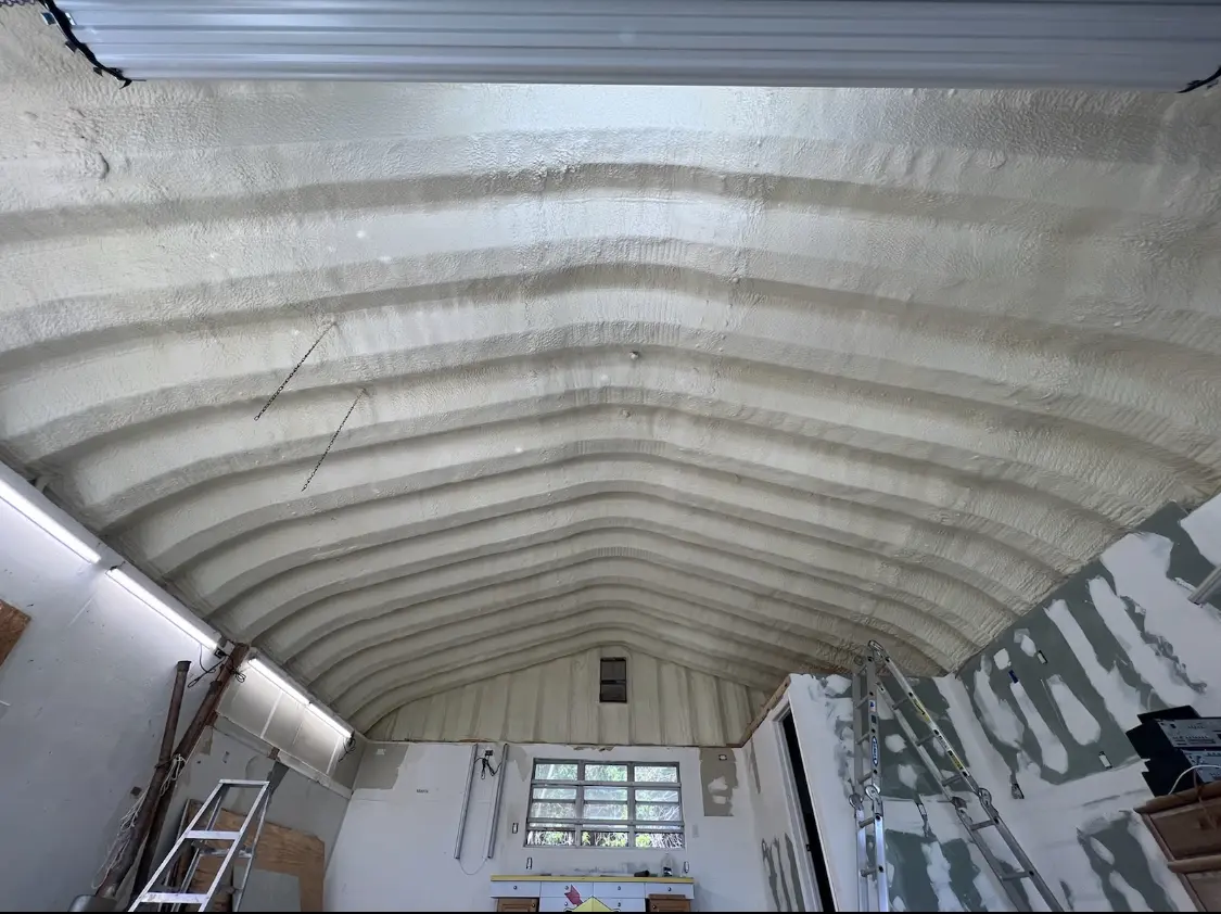 Spray polyurethane foam applied to the underside of a metal roof deck in Northfield